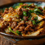 Chinese Ground Beef & Cabbage stir fry served in a rustic bowl with a glossy soy glaze.