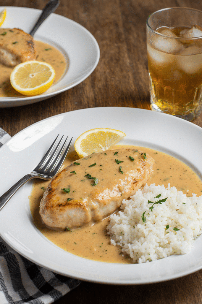 Plated creamy chicken with lemon sauce and rice