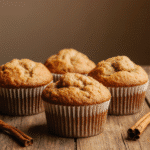 Irresistible Apple Cinnamon Muffins You Must Try There is something magical about the smell of cinnamon and baked apples filling a cozy kitchen. It is the kind of aroma that instantly makes you think of crisp autumn mornings, colorful leaves falling outside, and a warm oven promising comfort. These Irresistible Apple Cinnamon Muffins You Must Try are soft, moist, and brimming with flavor. With every bite, you get tender apple pieces tucked inside a fluffy crumb, kissed with cinnamon spice and a golden top that feels straight out of a country bakery. This recipe is more than just a breakfast idea. It is a hug in muffin form. Whether you enjoy them with your morning coffee, pack them for a lunchbox treat, or share them as part of your fall baking apple recipes tradition, they bring happiness to the table. These are the best apple muffins you will make, and once you try them, you will want to bake them all season long. Unlike some muffins that lean too sweet or too dense, these strike the perfect balance. They are fluffy without being dry, sweet without being overwhelming, and wholesome enough to enjoy any time of the day. With simple ingredients like fresh apples, warm cinnamon, and a touch of brown sugar, this recipe proves that fall flavored muffins can be both comforting and easy to make. Why These Muffins are Special Muffins come in many flavors, but apple cinnamon muffins hold a timeless charm. They are part of a collection of fall baked goods recipes easy enough for busy mornings but still worthy of a weekend brunch. The combination of soft apple pieces with the spice of cinnamon creates a depth of flavor that reminds many of homemade apple pie, only faster and more portable. Here are a few reasons why these homemade apple muffins stand out: Moist and Tender Crumb: Thanks to the juicy apples and a touch of yogurt, these muffins stay soft and delicious even the next day. Perfect Fall Flavors: Cinnamon bake notes give them warmth, while apple chunks bring bursts of sweetness. Easy to Make: With just one bowl and pantry staples, you will have muffins ready in less than an hour. Versatile Add-Ins: Add pecans for apple pecan muffins, swap in pears for a twist, or top with streusel for extra indulgence. Family-Friendly: They are loved by kids and adults alike, making them the ultimate fall breakfast treat. Ingredients for Irresistible Apple Cinnamon Muffins The beauty of this recipe is that you do not need fancy baking tools or specialty items. Everything comes together with familiar, cozy ingredients that are likely already in your pantry. 2 cups all-purpose flour 1 ½ teaspoons baking powder ½ teaspoon baking soda 1 teaspoon ground cinnamon ½ teaspoon nutmeg ½ teaspoon salt ½ cup unsalted butter, melted and cooled ½ cup brown sugar ¼ cup granulated sugar 2 large eggs, room temperature 1 teaspoon pure vanilla extract ¾ cup Greek yogurt or sour cream 1 ½ cups fresh apples, peeled and finely chopped (Honeycrisp or Granny Smith work best) Optional: ½ cup chopped pecans or walnuts For a topping, you can sprinkle extra cinnamon sugar or prepare a simple streusel with flour, butter, and sugar if you want a bakery-style finish. Step by Step Instructions Step 1. Prepare your oven and pans Preheat your oven to 375°F and line a 12-cup muffin pan with paper liners. If you prefer, you can lightly grease the cups with butter or non-stick spray. Step 2. Mix the dry ingredients In a large mixing bowl, whisk together flour, baking powder, baking soda, cinnamon, nutmeg, and salt. This ensures the spices are evenly distributed. Step 3. Whisk the wet ingredients In another bowl, combine melted butter, brown sugar, granulated sugar, eggs, and vanilla. Whisk until smooth and slightly thickened. Stir in the yogurt until fully combined. Step 4. Combine the batters Slowly fold the wet mixture into the dry mixture, stirring just until the flour disappears. Do not overmix, as this can make muffins tough. Step 5. Add apples and mix-ins Fold in the chopped apples and pecans if using. The batter will be thick, but this ensures hearty muffins. Step 6. Fill and top Divide the batter evenly among the muffin cups, filling each about three-quarters full. Sprinkle with cinnamon sugar or streusel topping if desired. Step 7. Bake and cool Bake for 18–22 minutes, or until a toothpick inserted in the center comes out clean. Let muffins cool for at least 10 minutes before serving. Serving Versatility These muffins are delightful on their own, but you can serve them in so many ways. Enjoy them warm with a pat of butter, slice them in half and spread with cream cheese, or drizzle with honey for an extra cozy touch. They make an excellent addition to breakfast spreads, brunch tables, or even as a sweet afternoon snack with tea. For a creative twist, try serving them slightly warmed with a scoop of vanilla ice cream as a mini dessert. Pro Tips for Success Use fresh, crisp apples for the best flavor and texture. Granny Smith apples add tartness, while Honeycrisp brings natural sweetness. Do not overmix the batter. Stir gently until just combined to keep the muffins tender. For bakery-style tops, fill the muffin cups nearly to the brim. Let the muffins rest in the pan for a few minutes before transferring them to a cooling rack to avoid breaking. Add a streusel topping if you want extra crunch and sweetness. Common Mistakes to Avoid Overmixing: This can lead to dense muffins instead of a light crumb. Too much apple: While tempting, adding more than recommended can make the muffins soggy. Skipping yogurt or sour cream: This is what gives moisture and a soft crumb, so do not leave it out. Not measuring flour correctly: Always spoon and level flour to avoid dry muffins. Storage and Reheating These muffins store well, making them perfect for meal prep and quick breakfasts. Room Temperature: Store in an airtight container for up to 3 days. Refrigerator: Keep for up to 6 days, though the texture is best when warmed before serving. Freezer: Wrap individually and freeze for up to 2 months. To enjoy, thaw at room temperature or warm in the microwave for 20–30 seconds. Nutritional Information Prep Time: 15 minutes Cook Time: 20 minutes Total Time: 35 minutes Servings: 12 muffins Calories: ~210 per muffin FAQs Can I use whole wheat flour? Yes, though the muffins will be slightly denser. Try half whole wheat and half all-purpose for a balance. Can I make these dairy-free? Use coconut oil instead of butter and a dairy-free yogurt alternative. Do I need to peel the apples? Peeling creates a softer texture, but you can leave the skin on for added fiber and color. What other spices can I add? Cloves or allspice work beautifully in small amounts for a deeper fall flavor. Closing Thoughts Irresistible Apple Cinnamon Muffins You Must Try – Cozy Fall Baking So, gather your apples, dust off your muffin tin, and let the cinnamon bake magic happen in your kitchen. Bake a batch, share them with loved ones, and watch how fast they disappear. Final Thoughts from Emma I love baking these muffins when the leaves outside start to change. There is something about apple pecan muffins and the smell of cinnamon that makes my whole house feel like home. If you try them, I would love to know how you serve them. Do you enjoy them plain or with a drizzle of honey? Follow me on Pinterest for more cozy, quick, and nostalgic recipes. And if you loved this recipe, do not miss my [Pumpkin Streusel Muffins] for another comforting favorite.