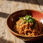 Close Up Of 10 Minute Chili Oil Udon Noodles In A Rustic Ceramic Bowl Vibrant Red And Golden Colors U1k9tys2ilw8e1kju9ln 0
