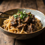 Close Up Of Beef And Noodles In A Rustic Bowl Vibrant Colors Cozy Natural Daylight Blurred Wooden F 7n7i93nvuzq26x5vgqp7 0