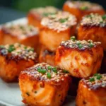 Bang Bang Salmon Bites served in a bowl with garnishes
