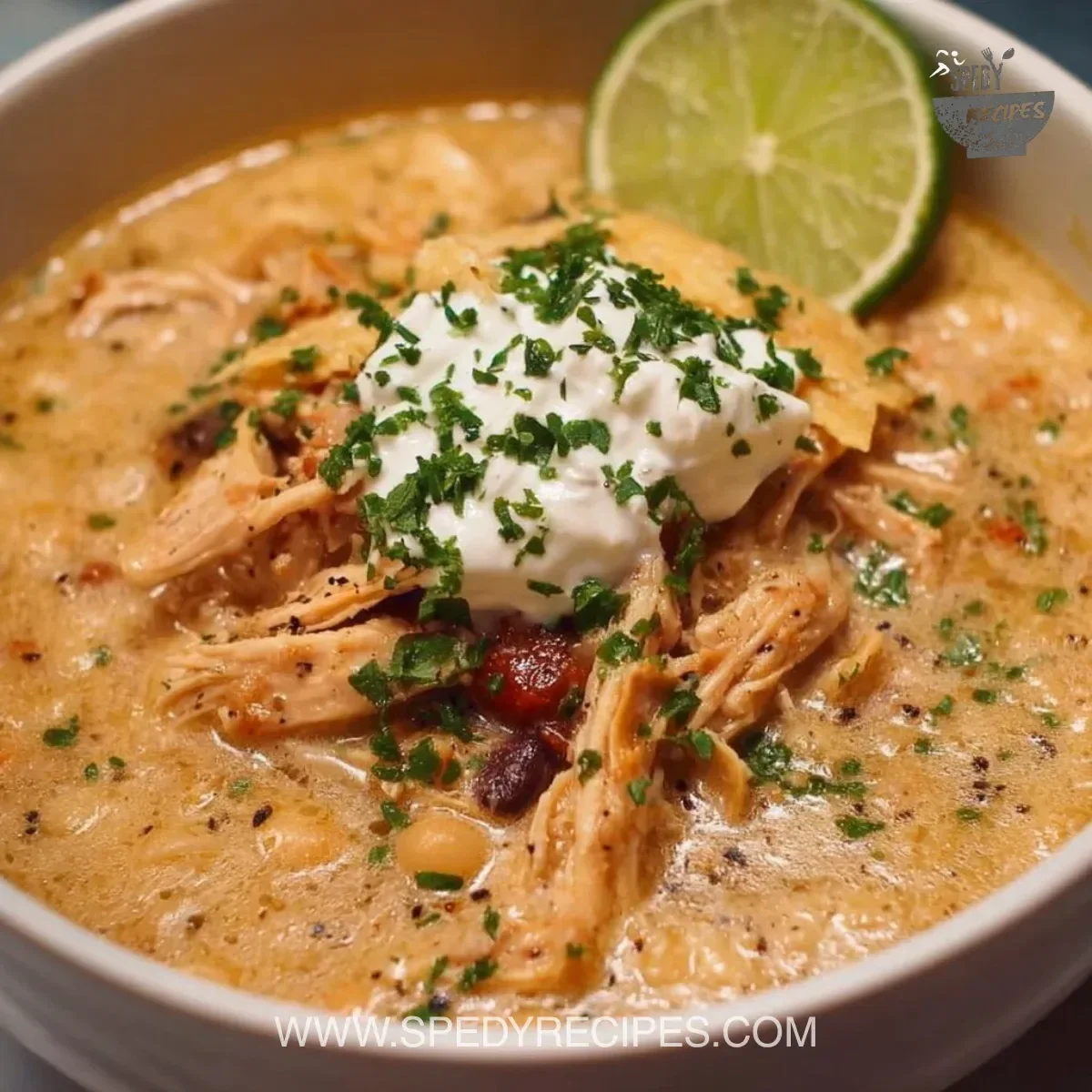 Crockpot White Chicken Chili with Cream Cheese served in a cozy bowl