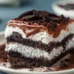 Delicious five layer Oreo lasagna dessert with creamy layers and chocolate toppings.