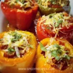 Colorful stuffed bell peppers filled with quinoa, beans, and vegetables.