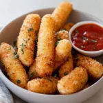 Delicious air fryer mozzarella sticks served with marinara sauce