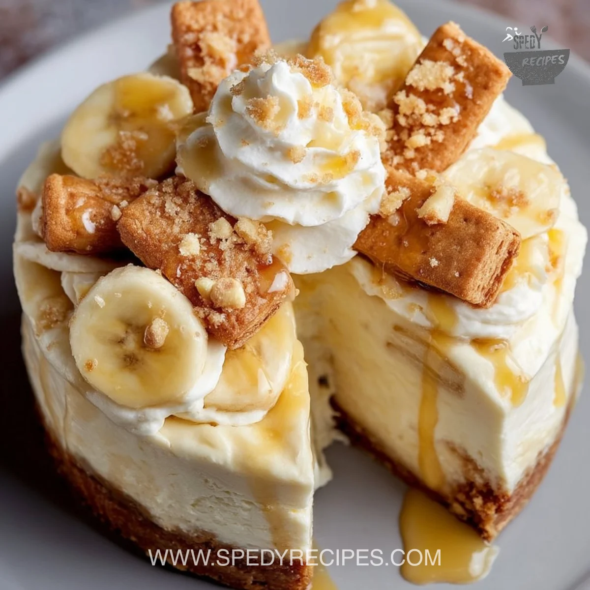 Slice of banana pudding cheesecake topped with bananas and whipped cream