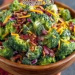 Delicious broccoli salad with bacon, nuts, and dressing on a plate