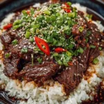 Delicious Slow Cooker Korean Beef served on a plate with garnishes.