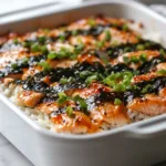 Delicious Spicy Salmon Sushi Bake served in a dish, garnished and ready to eat.
