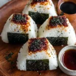 Delicious spicy tuna rice ball garnished with sesame seeds and green onions.