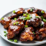 Blackstone Bourbon Chicken served hot on a plate with garnishes