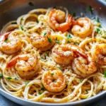 Crispy Shrimp Scampi Linguine garnished with herbs and lemon zest