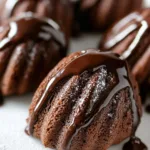 Delicious double chocolate madeleines on a plate, perfect dessert treat.