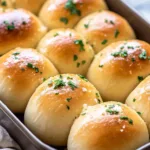 Freshly baked garlic bread rolls with herbs and butter