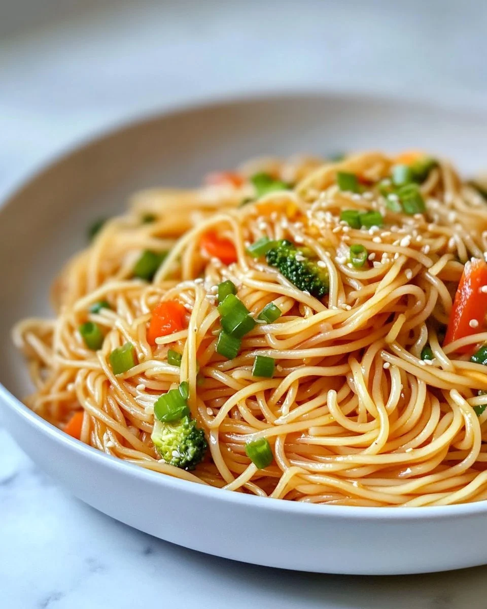 Garlicky Butter Noodle Stir-Fry with vegetables and herbs in a skillet