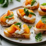 Simple peach bruschetta topped with whipped ricotta on a wooden serving board