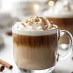 A delicious Vanilla Cinnamon Latte topped with whipped cream and cinnamon sprinkles.