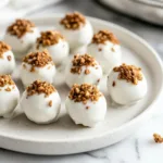 Homemade carrot cake truffles topped with cream cheese frosting and nuts