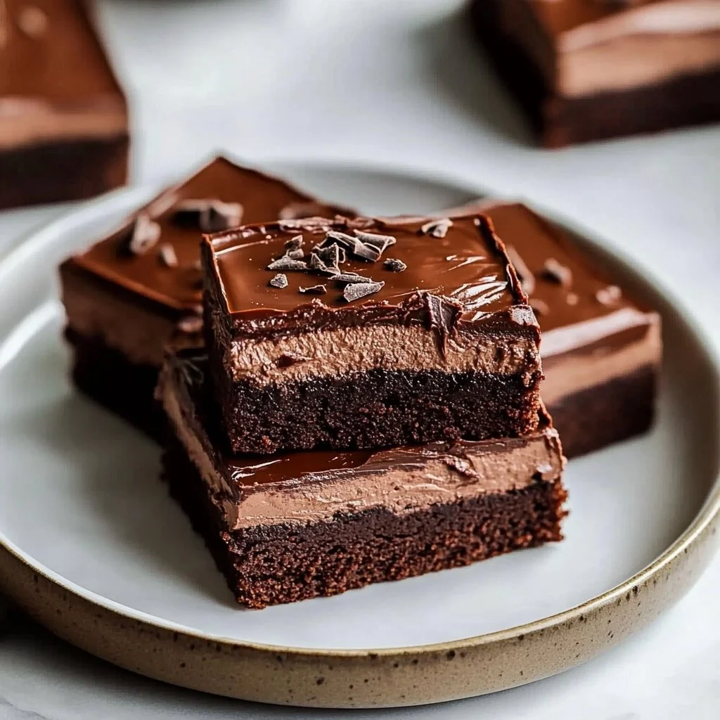 Decadent chocolate mousse brownies on a plate, tempting dessert