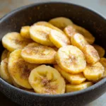 Cinnamon-sugar air fryer banana chips in a bowl