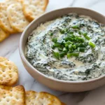 Delicious cold spinach dip served with fresh vegetables and crispy chips