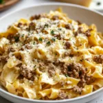 Creamy cheese pasta dish with ground beef served in a bowl