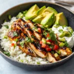 Delicious Honey Lime Chicken and Avocado Rice Stack presented on a plate.