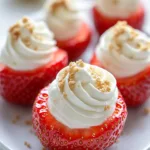 Deviled strawberries filled with cheesecake mixture on a white plate