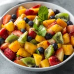 Fresh fruit salad topped with honey lime poppy seed dressing