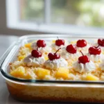 Hawaiian poke cake topped with coconut and pineapple for a tropical dessert experience