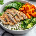 Healthy chicken and sweet potato rice bowl with fresh vegetables