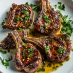 Honey garlic lamb chops served with sides on a plate