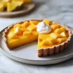 Delicious Mango Curd Tart with a golden crust and fresh mango topping