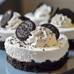 Delicious no-bake Oreo cheesecakes topped with crushed Oreos and whipped cream