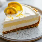 Tangy lemon cheesecake cake with a creamy filling and a golden crust