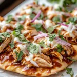 BBQ chicken flatbread topped with fresh ingredients and herbs