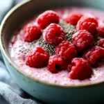 Delicious raspberry chia pudding topped with fresh berries and nuts