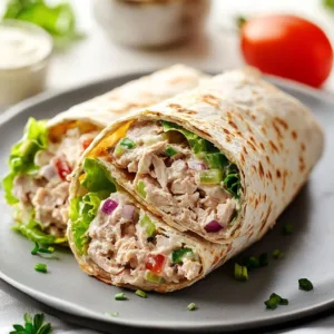Tuna Melt Wrap featuring creamy tuna, melted cheese, and fresh vegetables in a tortilla.