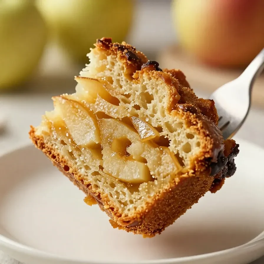 A loaf of freshly baked Amish apple fritter bread topped with a sweet glaze on a wooden table.